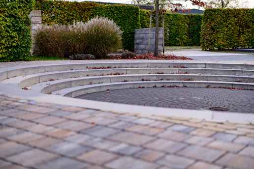 Curved stone steps surround a paved circular area