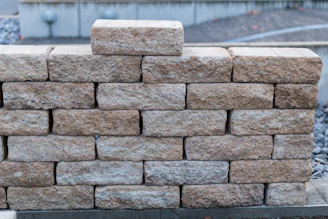A wall made of rough, tan-colored stones.