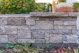 Stone wall with plants in the foreground