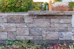 Stone wall with plants in the foreground