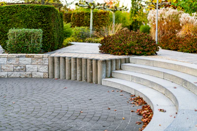 Curved stone steps lead through a manicured garden