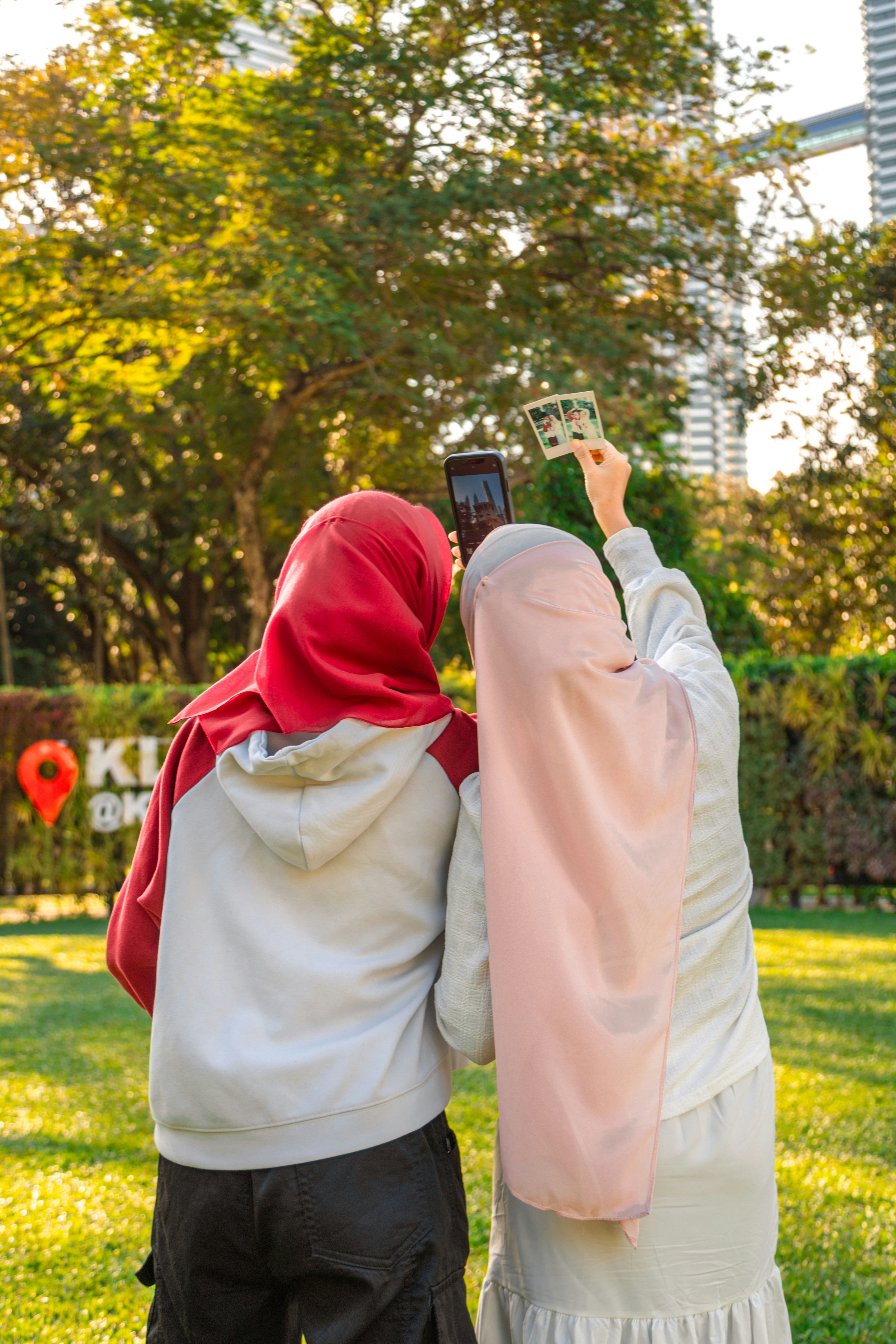 Two women taking a selfie in a park.