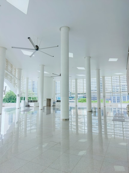 Modern white lobby with large pillars and reflective floor