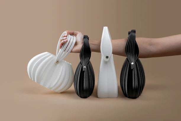 Four unique designer handbags on a neutral background