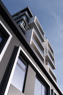 Modern building with geometric balconies against blue sky