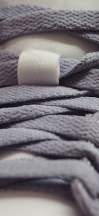 Close up of purple shoelaces with white tag.