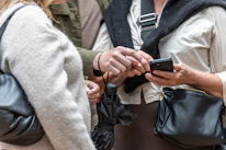 Two people looking at a smartphone screen together