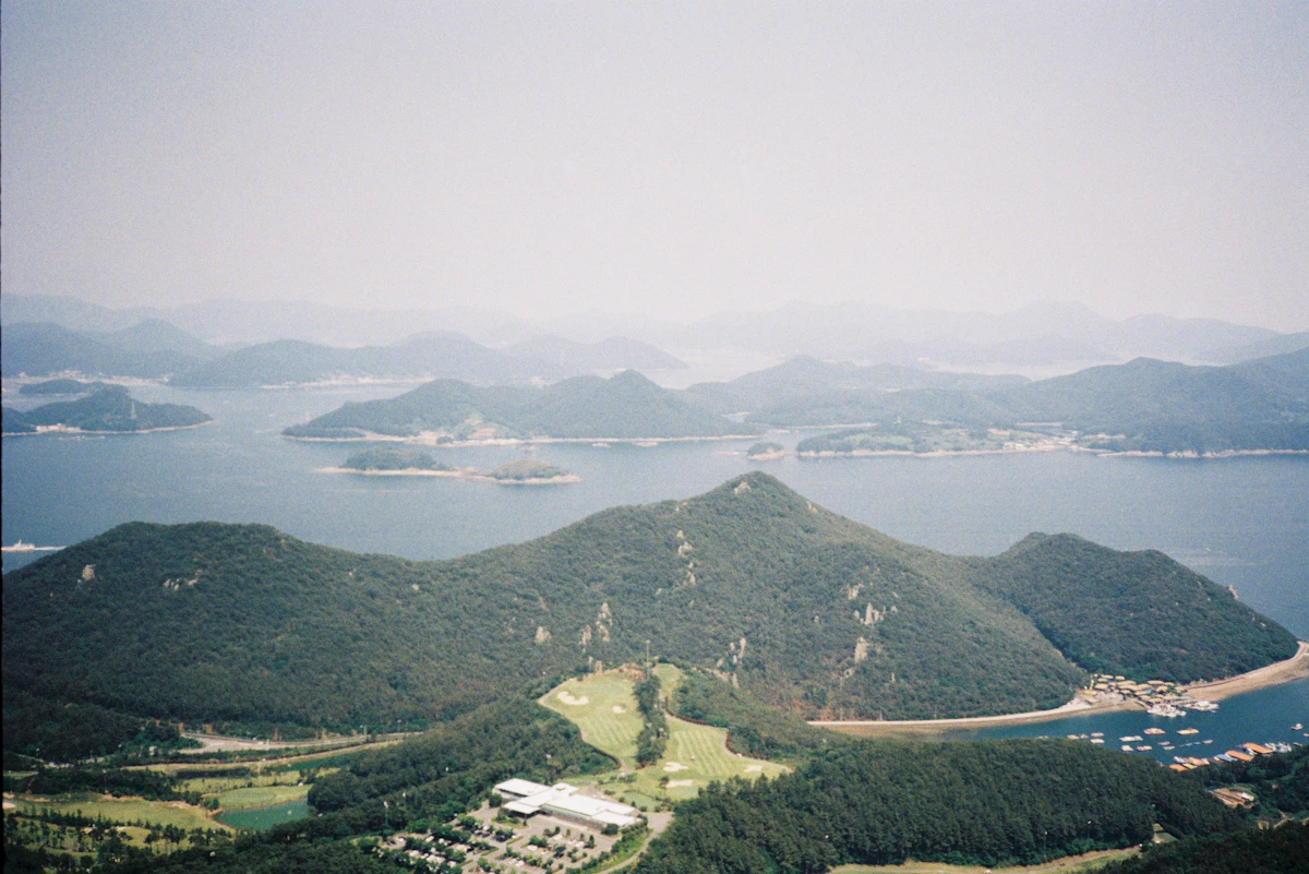 Green islands dot a tranquil blue sea.