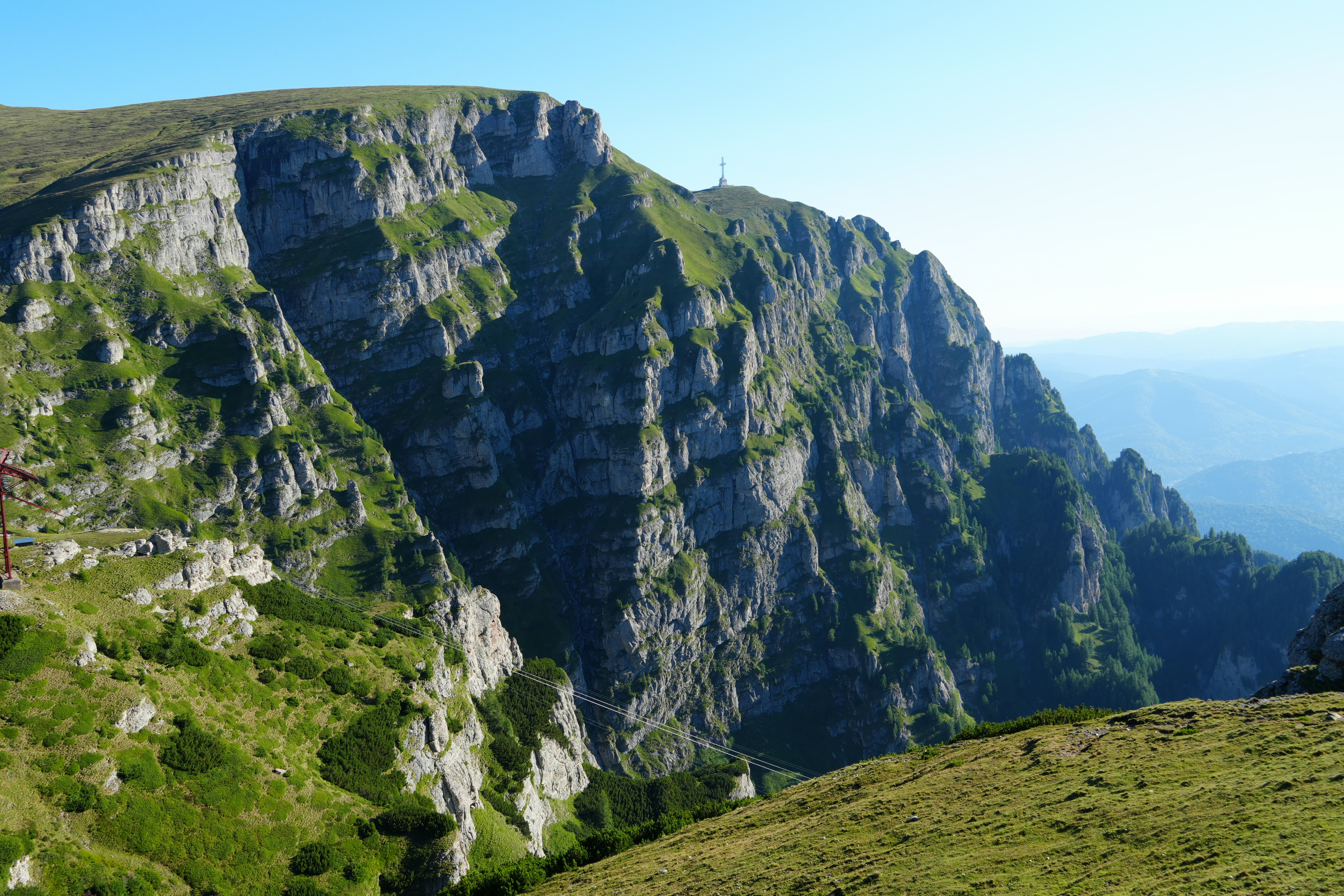 Rugged mountain cliffs covered in green vegetation