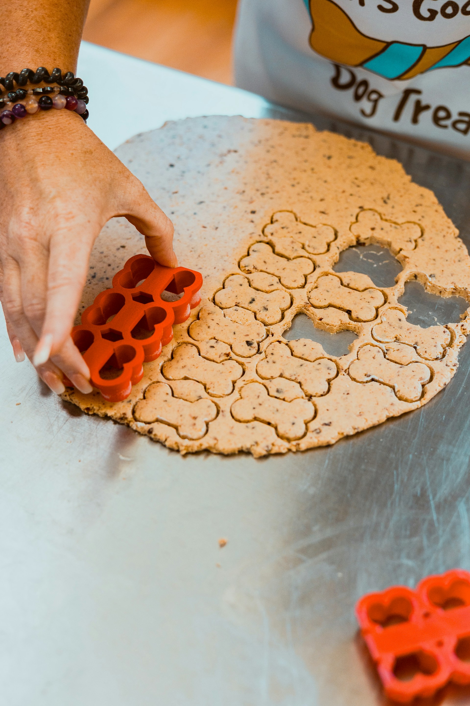 Cutting bone-shaped dog treats from dough