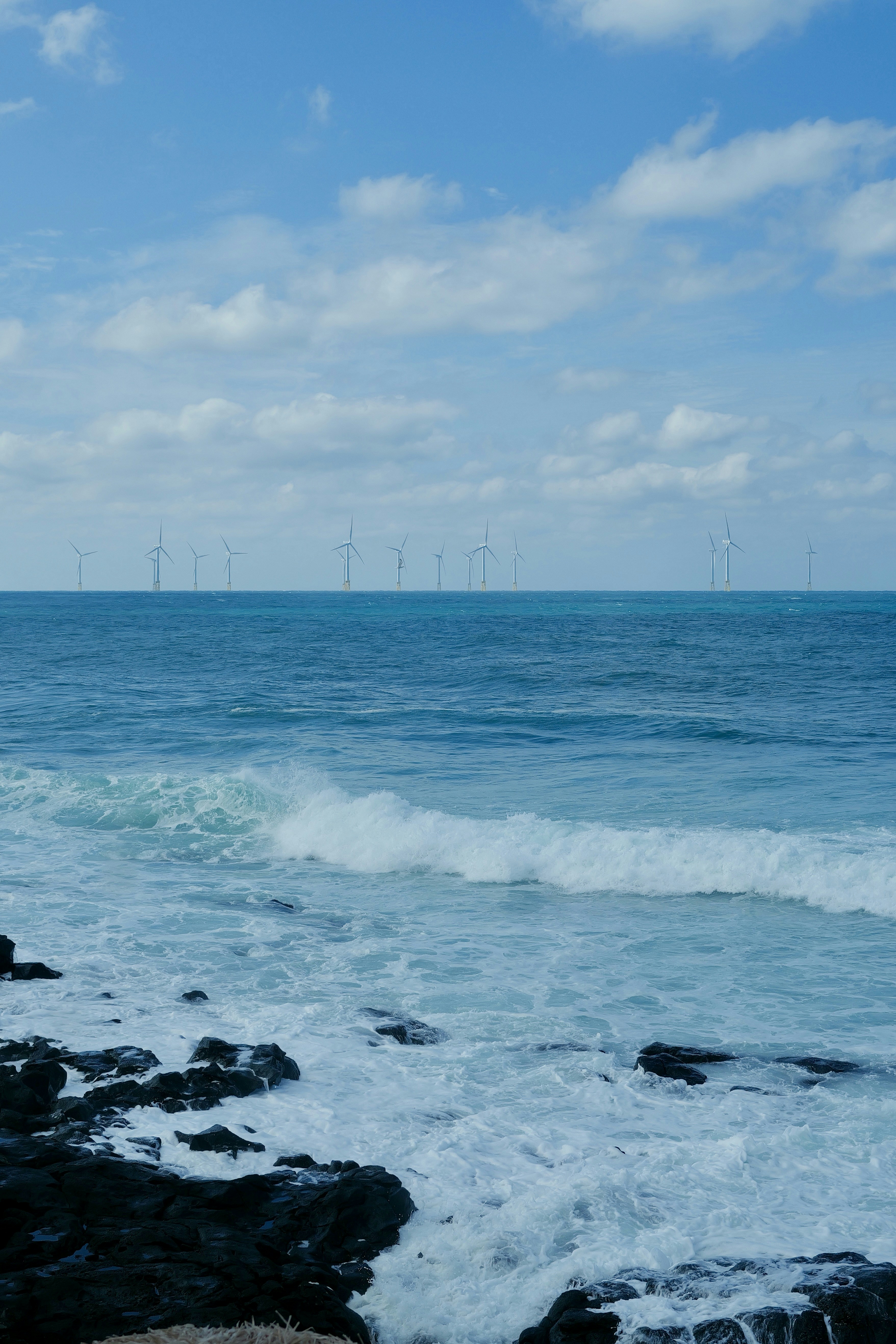 Wind turbines offshore on a cloudy day