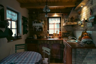 Rustic kitchen with checkered tablecloth and brick walls