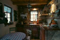 Rustic kitchen with checkered tablecloth and brick walls