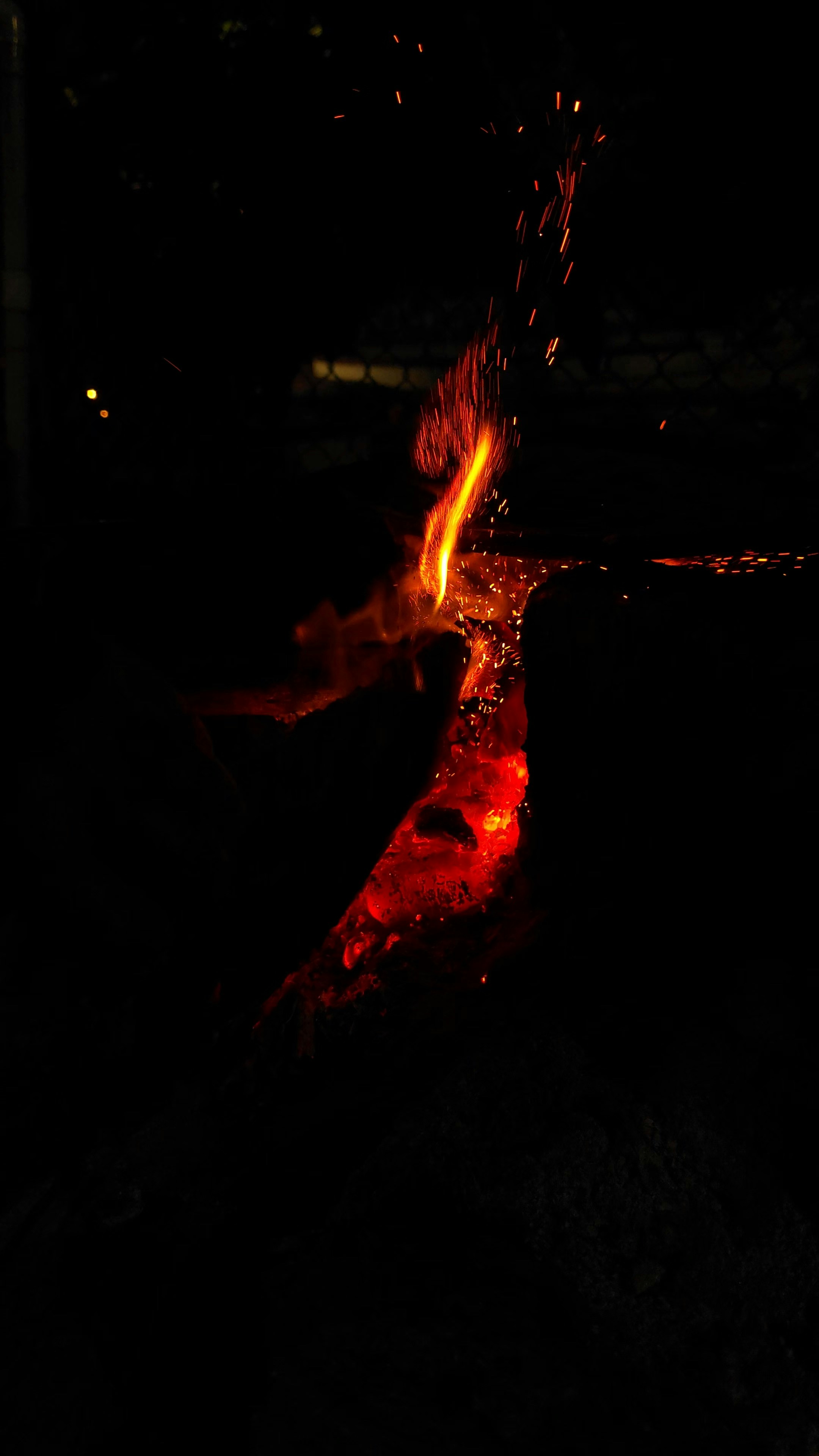 Glowing embers and flames in the dark