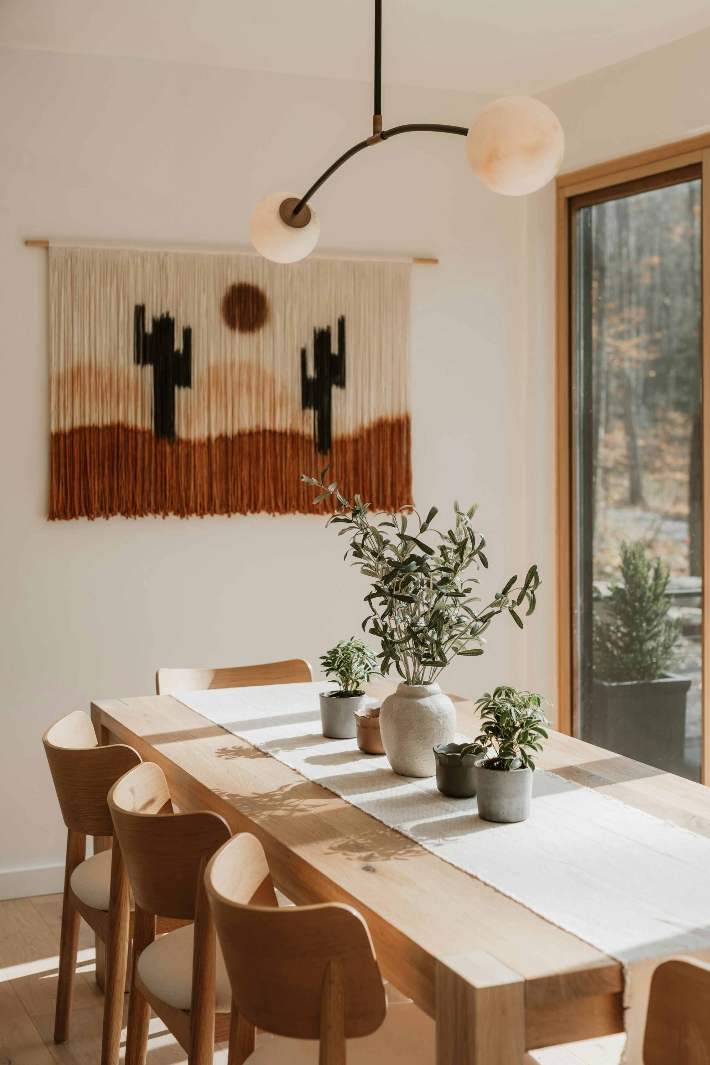 Dining table with desert-themed wall hanging