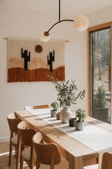 Dining table with desert-themed wall hanging