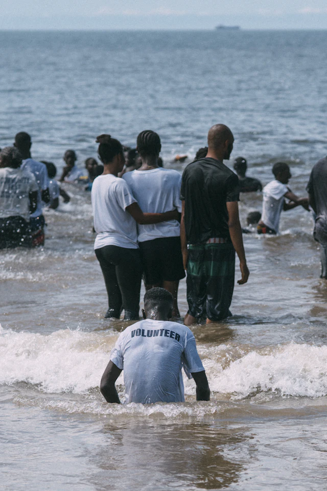 Volunteers supporting a community clean-up beside the water