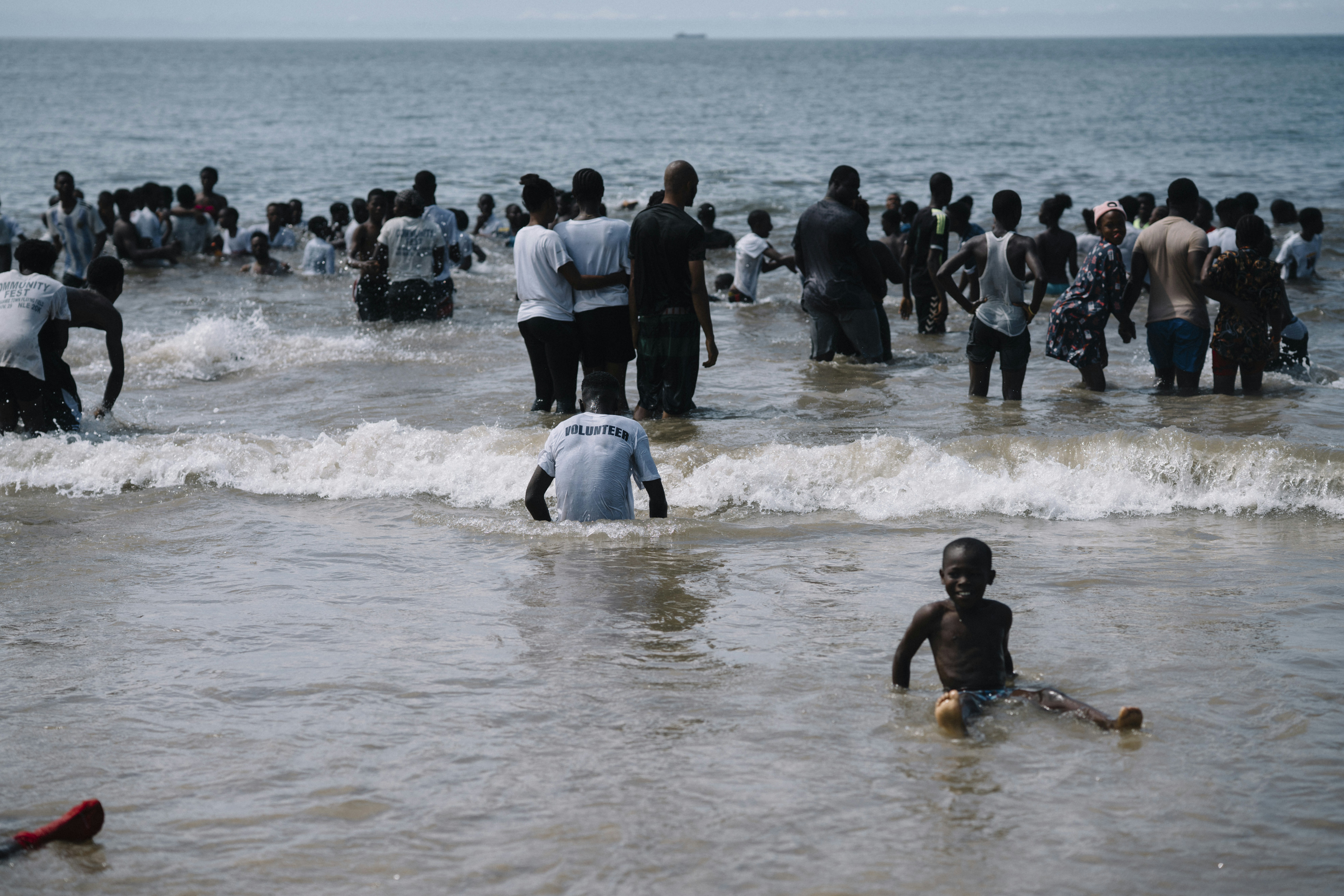People wading in ocean waves