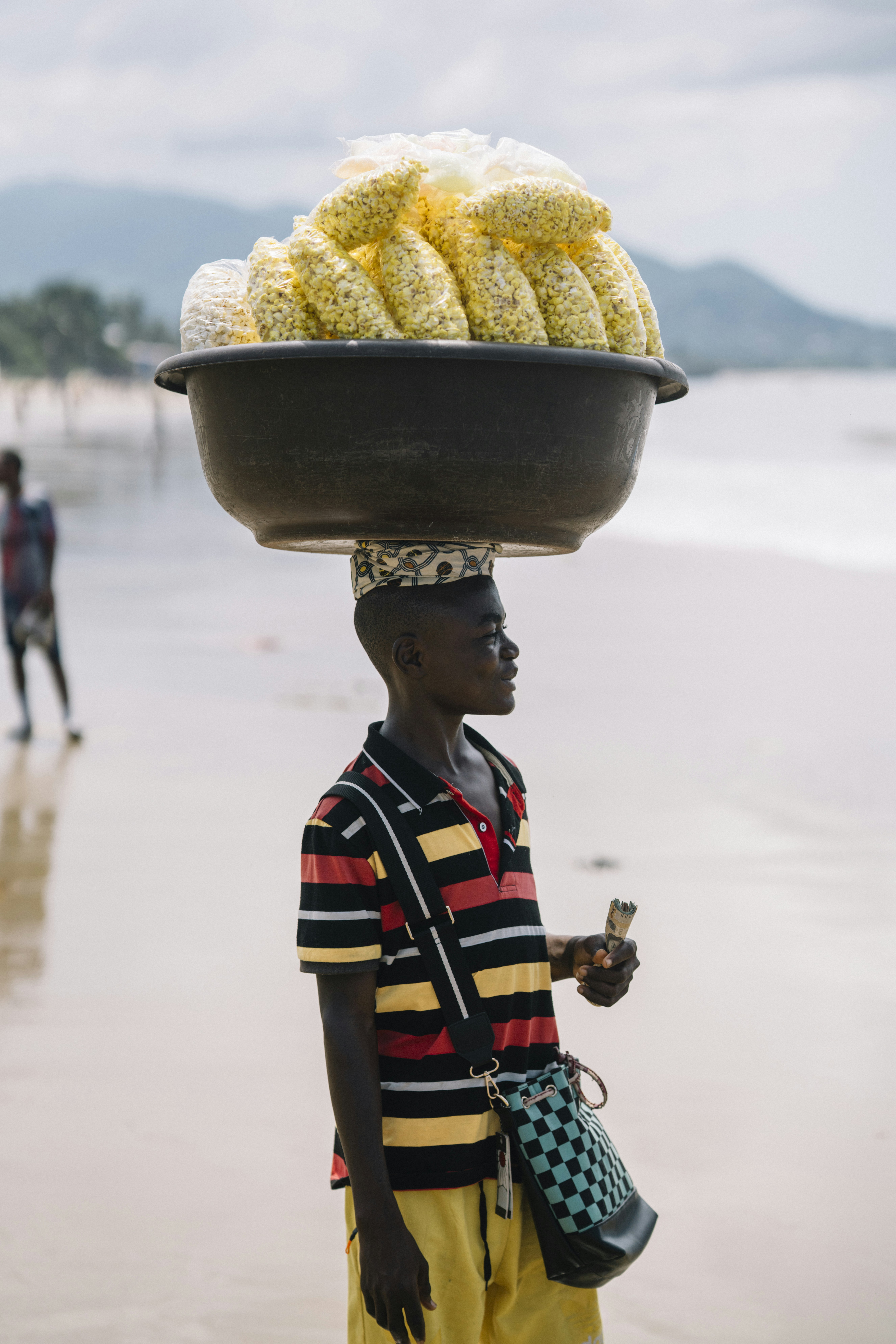 Young boy carrying popcorn on beach