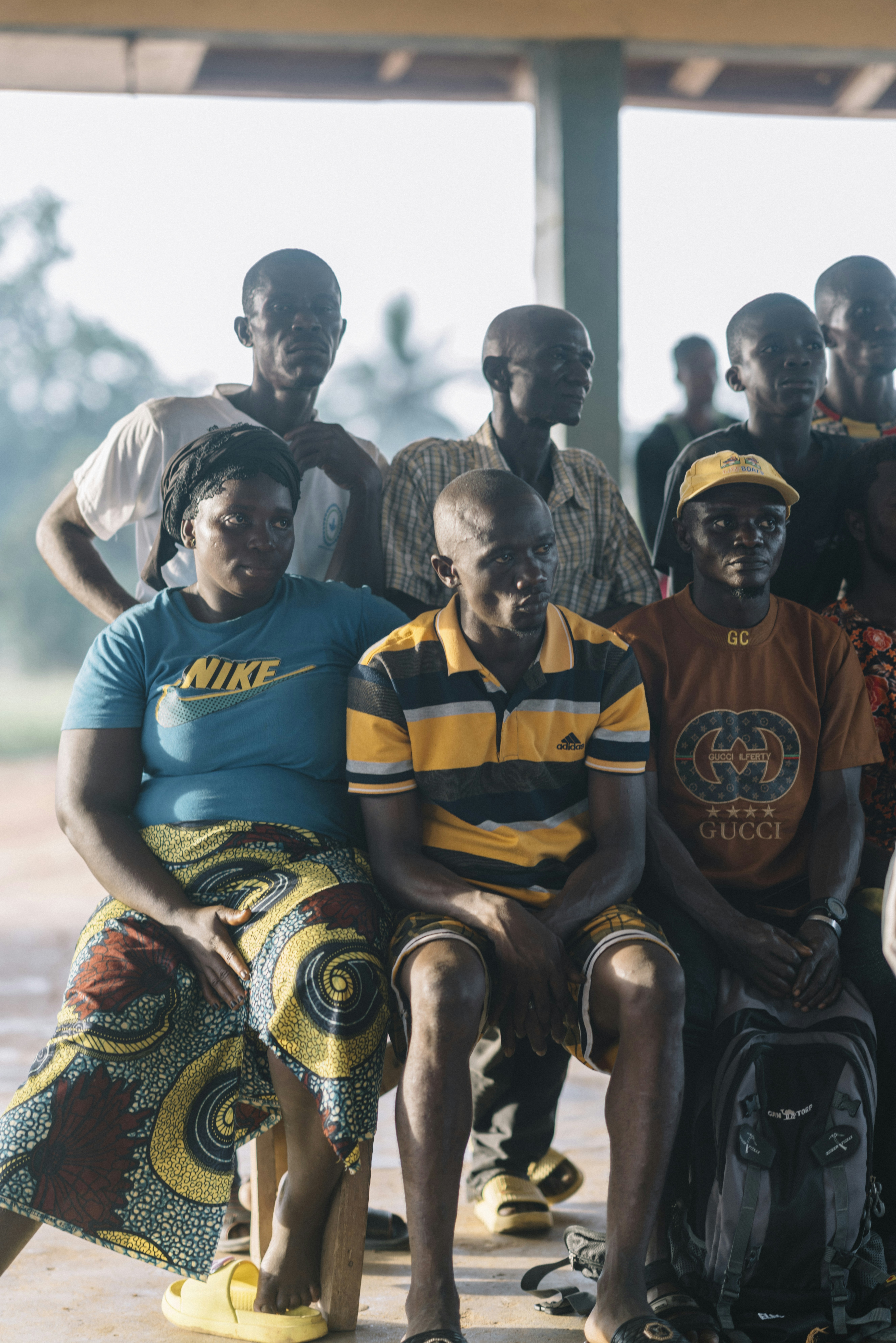 A group of people sitting together outdoors.