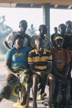 A group of people sitting together outdoors.