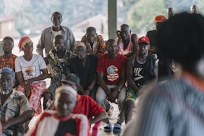 A group of people sitting and watching something.