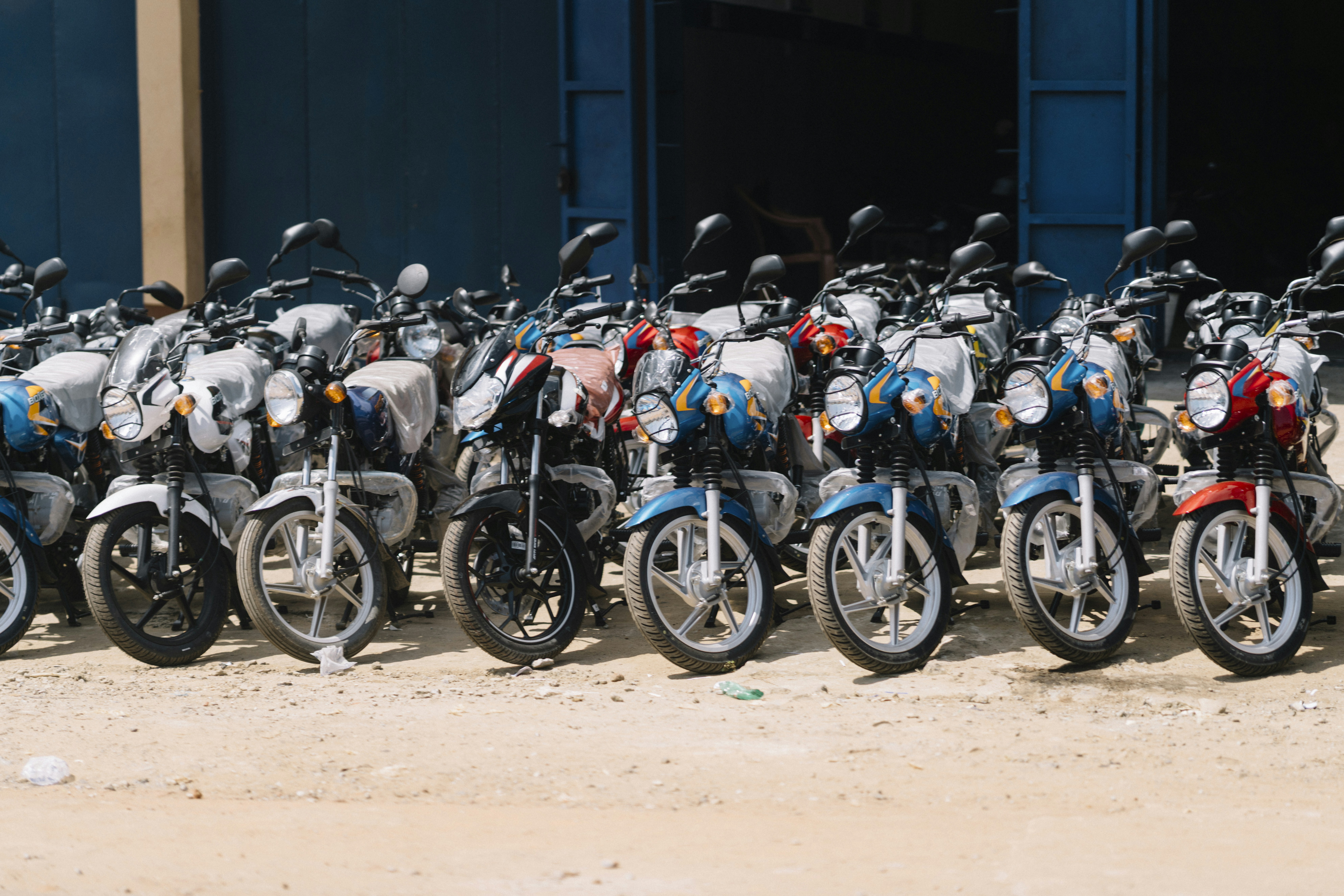 Many motorcycles parked in a row.