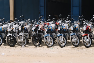 Many motorcycles parked in a row.