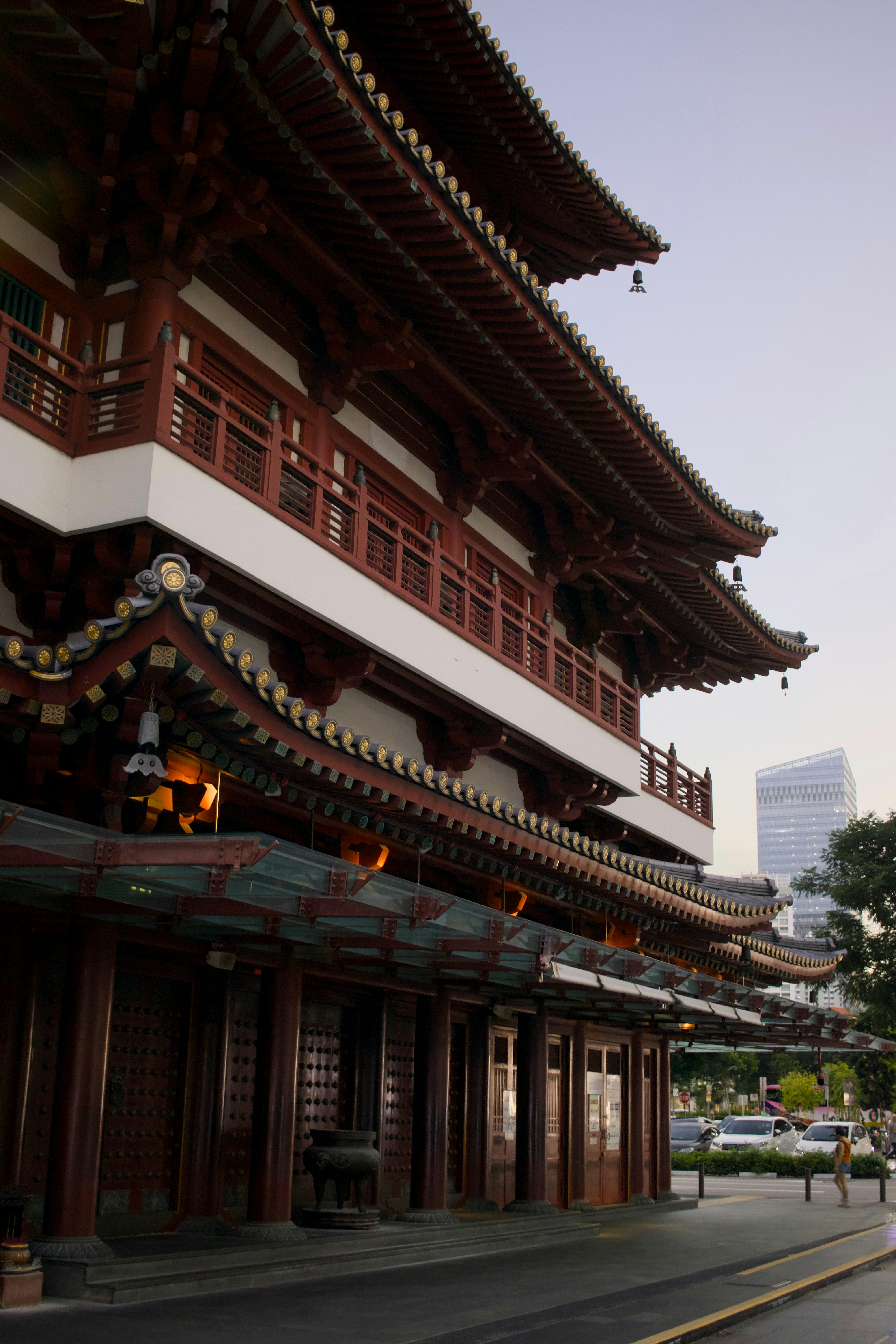 Traditional temple building with modern skyscrapers in background