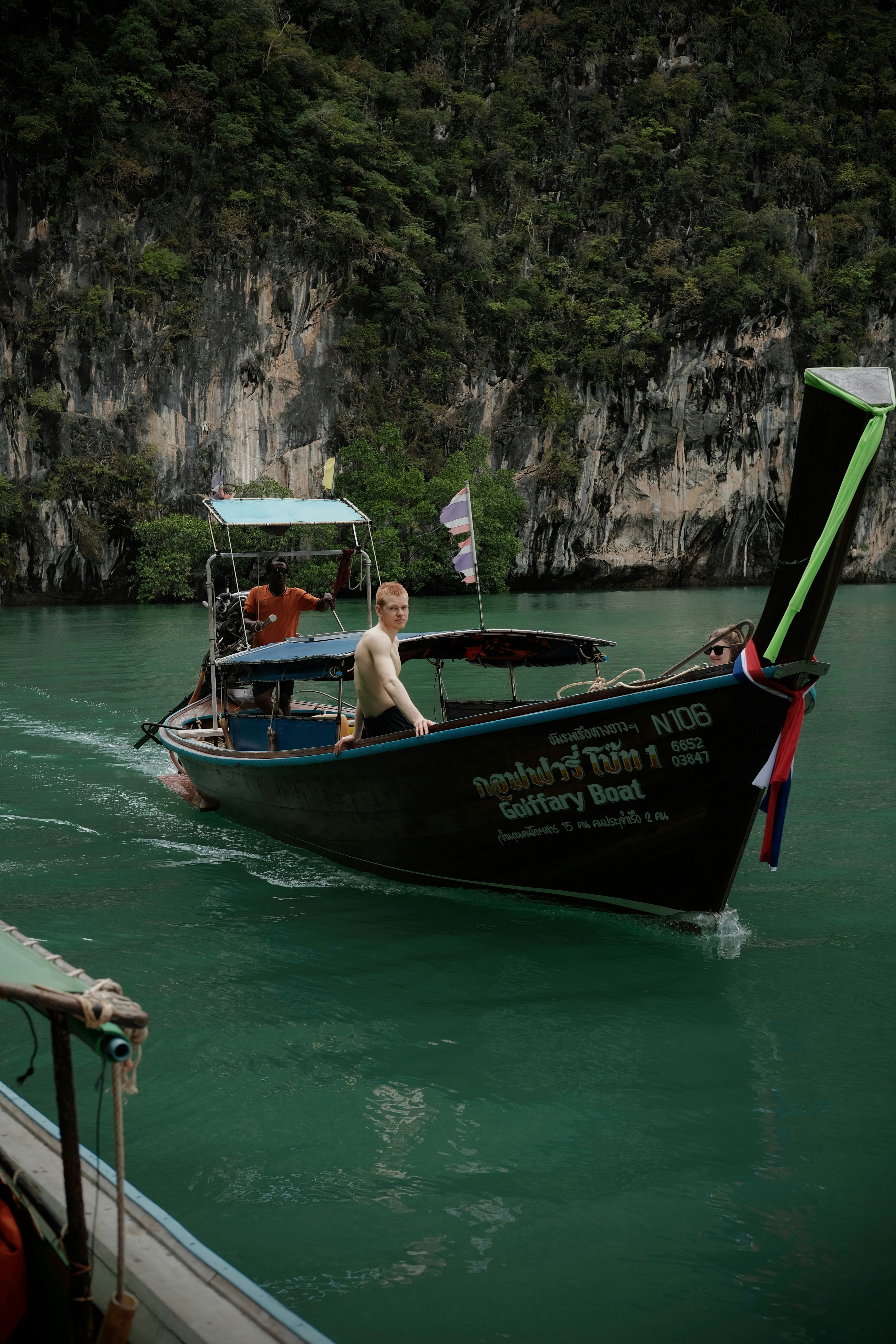 Man riding a traditional thai longtail boat