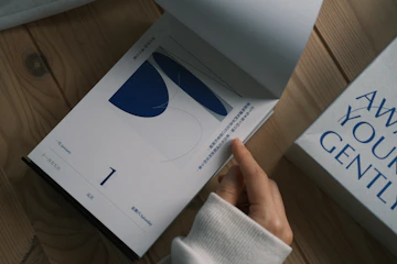 Hand turning pages of a minimalist notebook