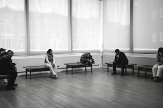 People sitting on benches in a room