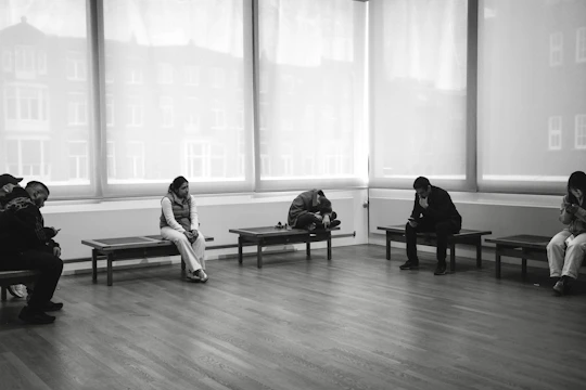 People sitting on benches in a room