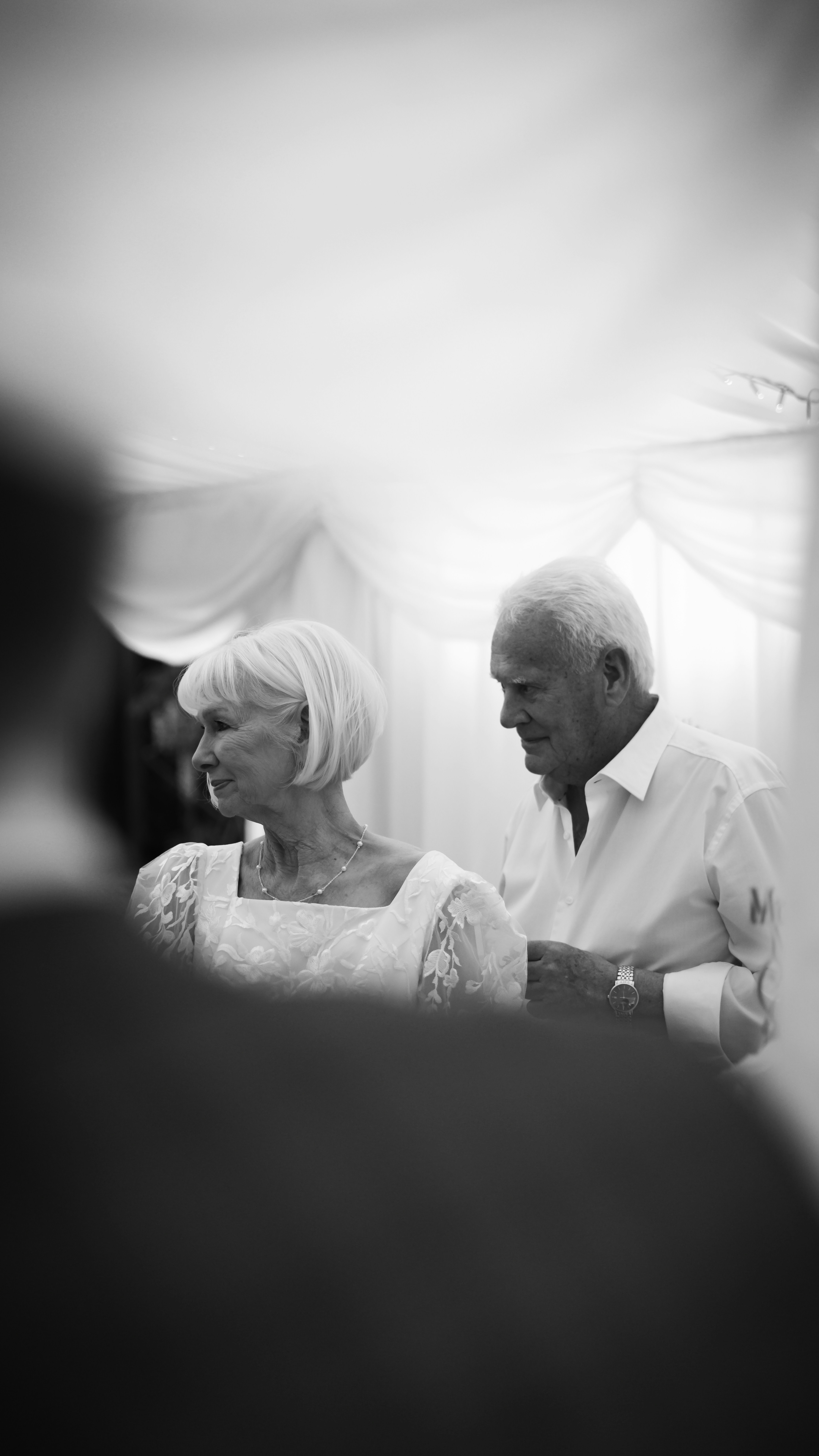 Elderly couple smiling at an event