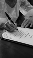 Woman signing a document with a pen