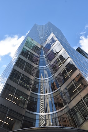 Modern glass skyscraper against a blue sky