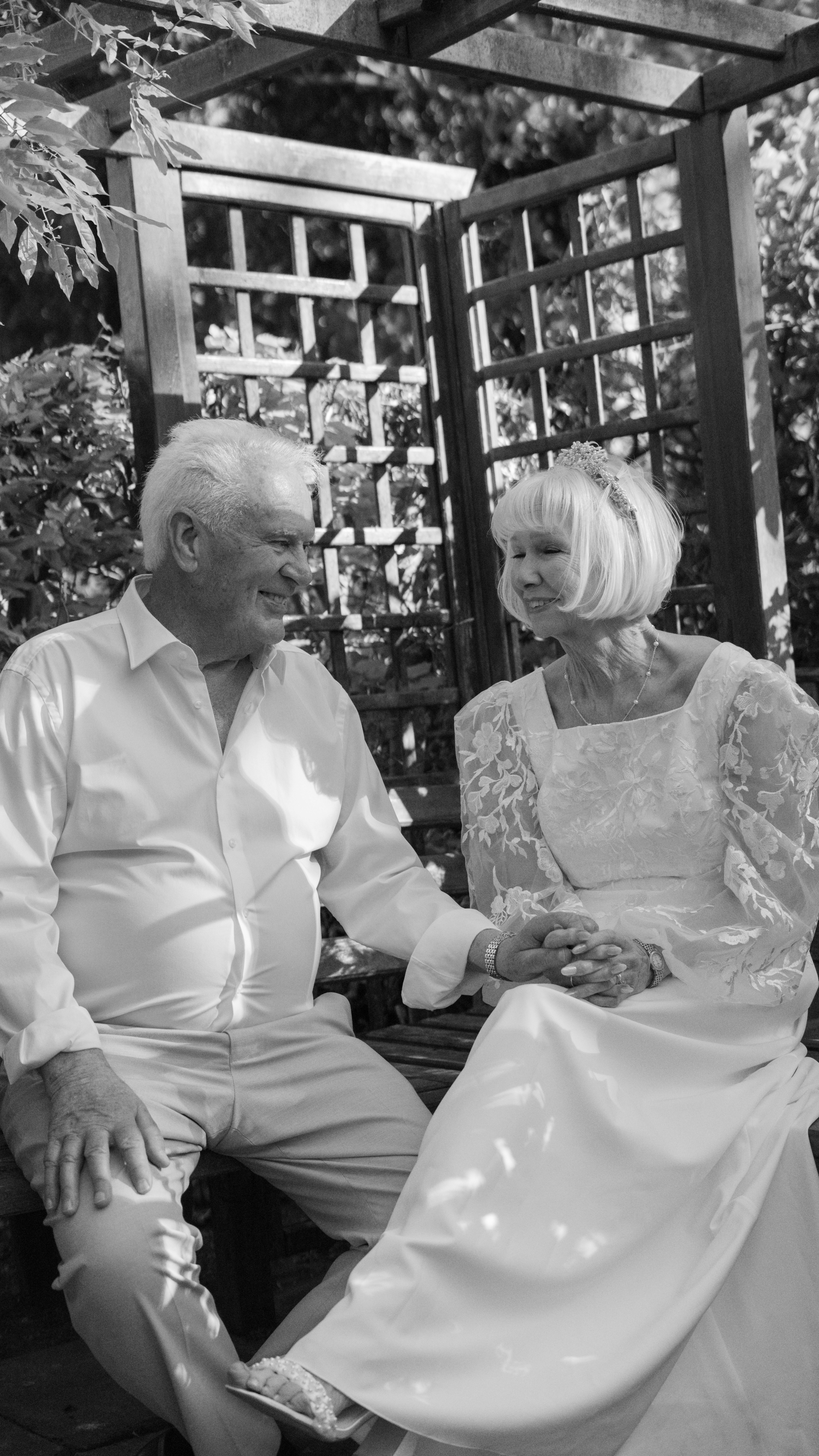 Elderly couple holding hands in garden