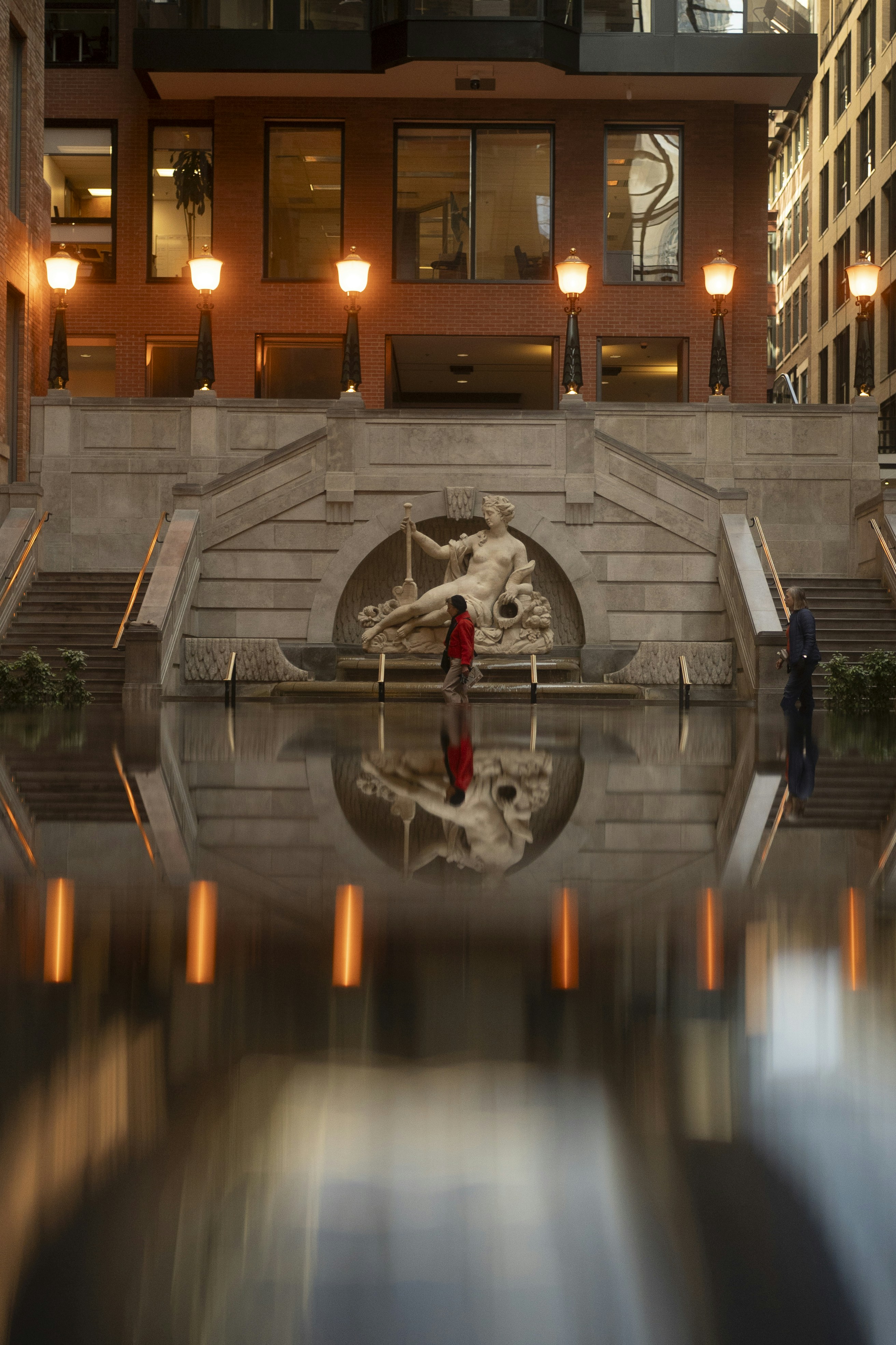 Building with fountain and reflection in-focus reflection