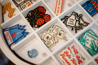 Various embroidered patches in a white organizer