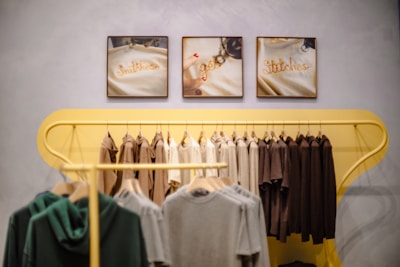 Clothing displayed on a yellow rack in a store.