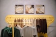 Clothing displayed on a yellow rack in a store.