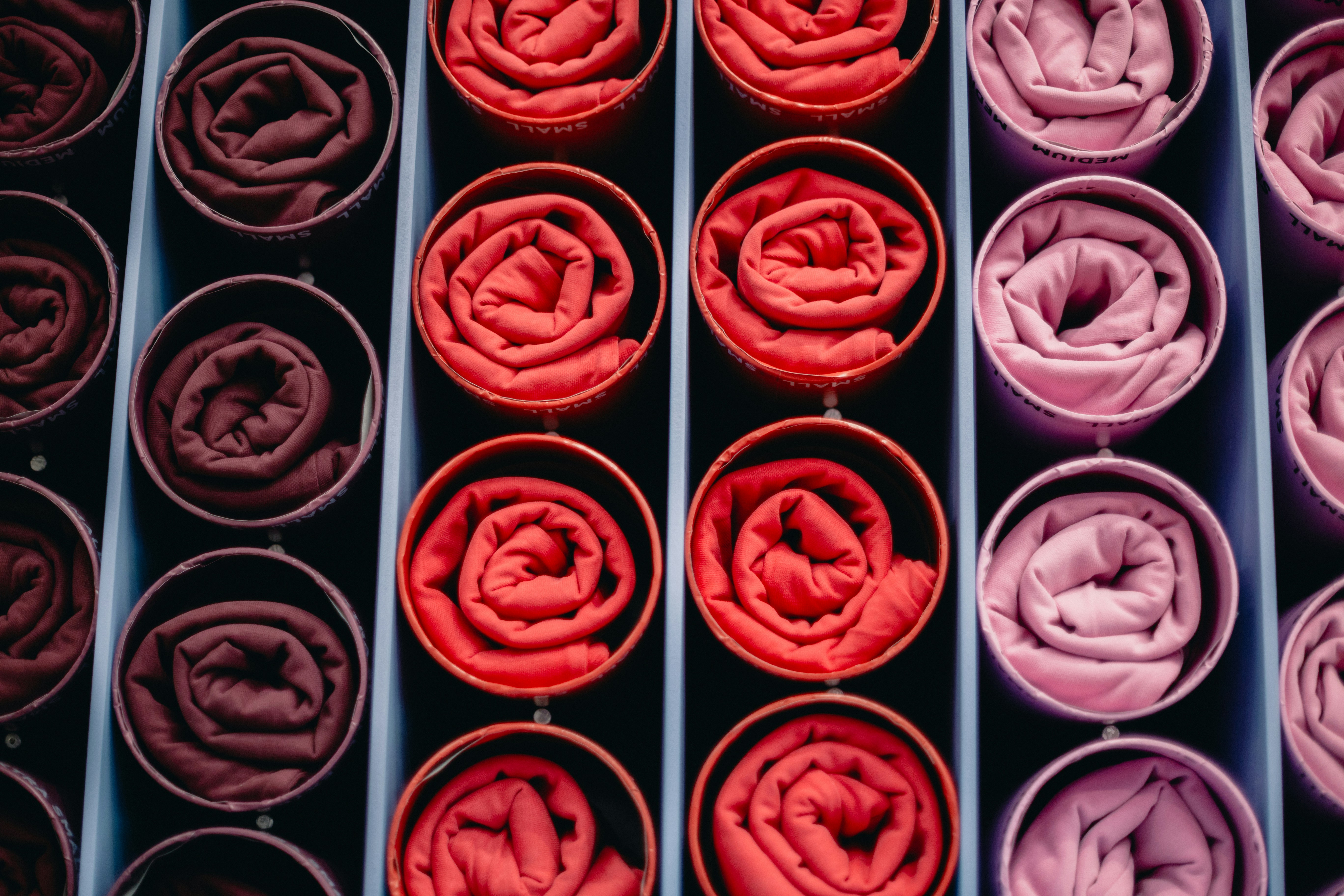 Rolled fabrics in shades of red and pink