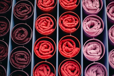 Rolled fabrics in shades of red and pink