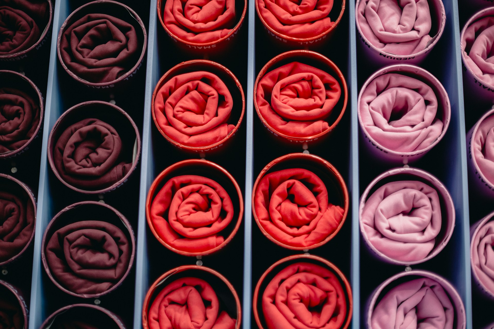 Rolled fabrics in shades of red and pink