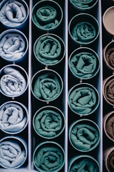 Rolled fabric samples in circular containers
