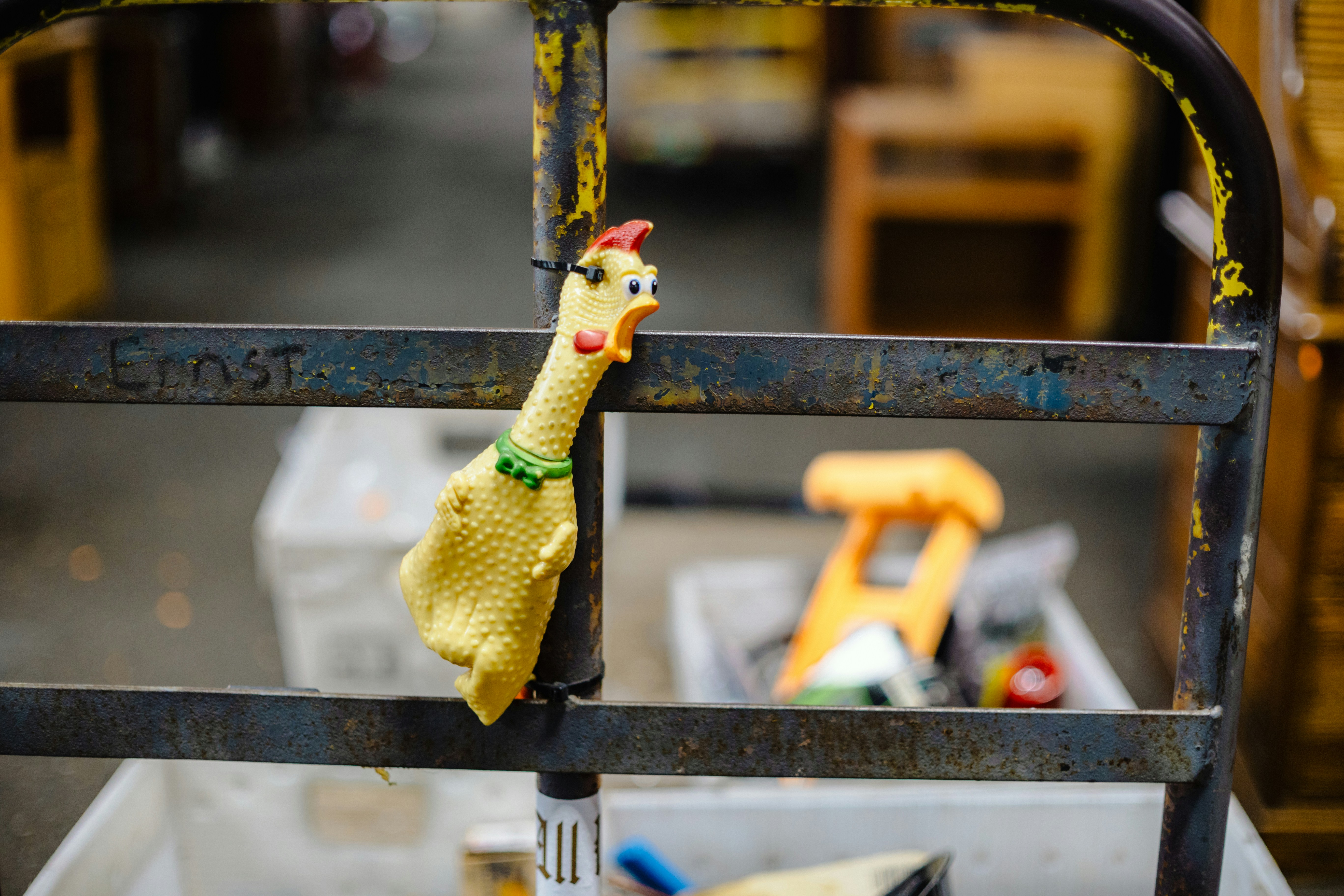 A rubber chicken hangs on a cart