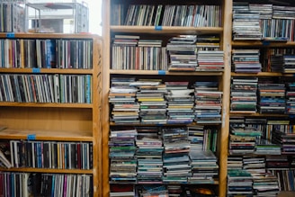 Wooden shelves filled with rows of cds and dvds.