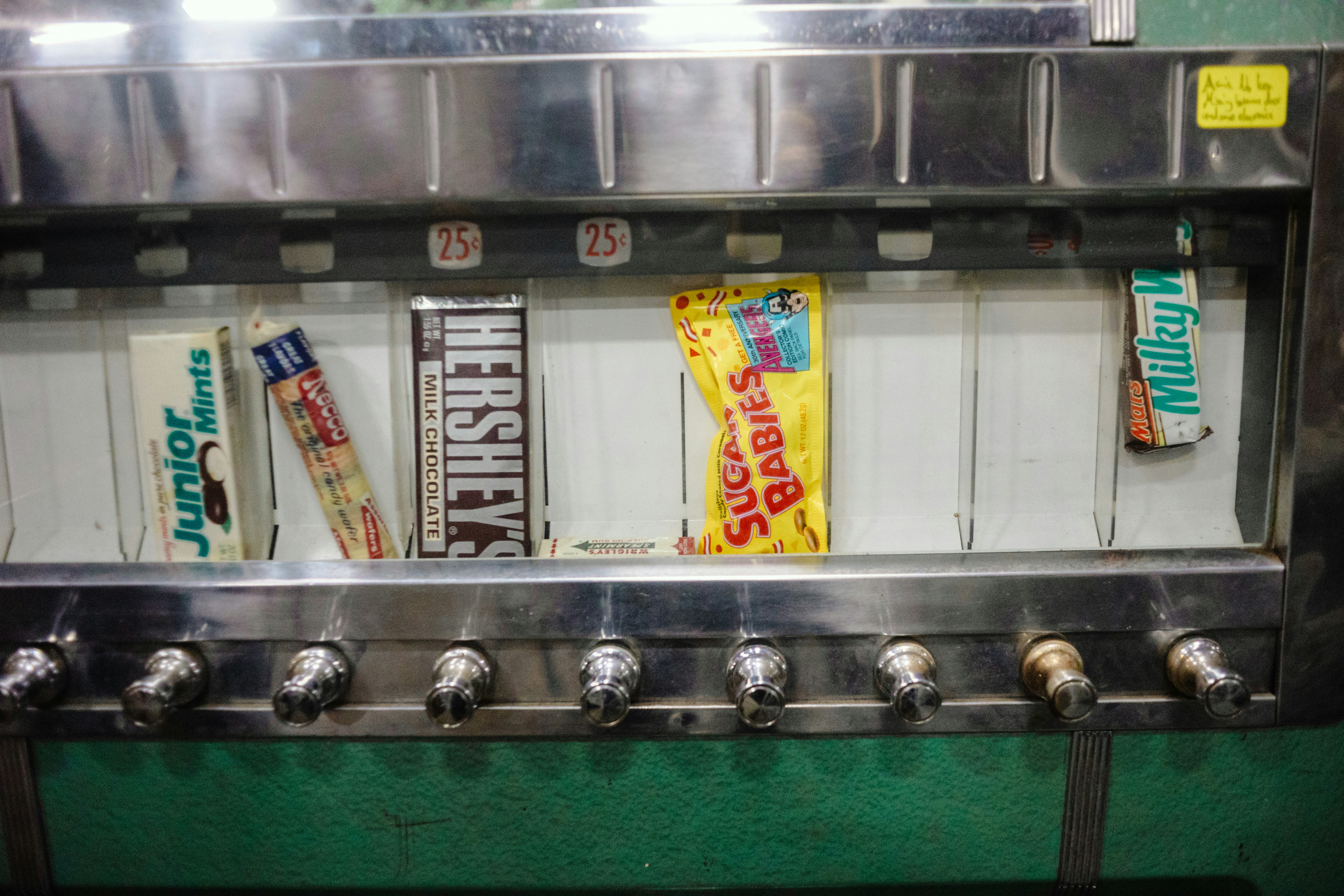 Candy bars displayed in a vending machine slots