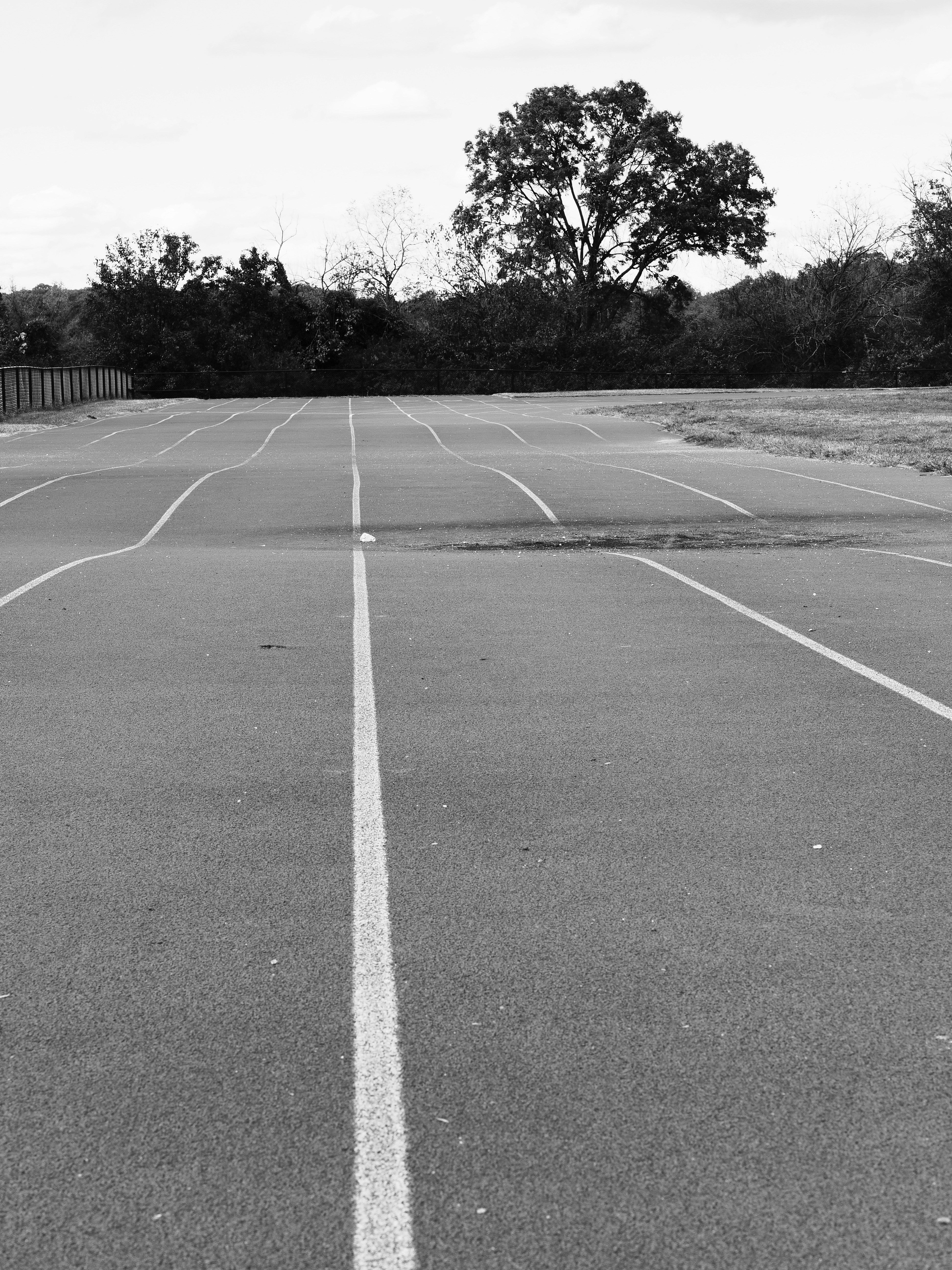 Empty running track with trees in background