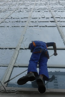 Window cleaner working on a glass building exterior